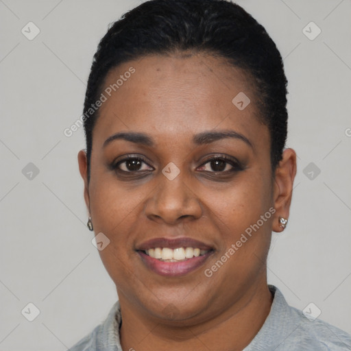 Joyful black young-adult female with short  black hair and brown eyes