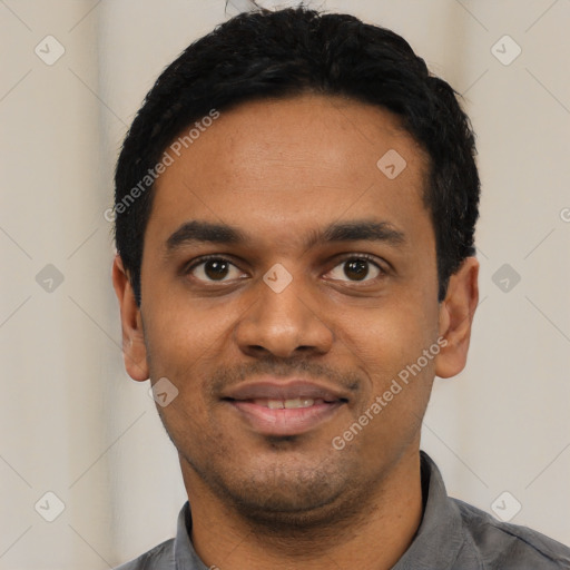 Joyful black young-adult male with short  black hair and brown eyes