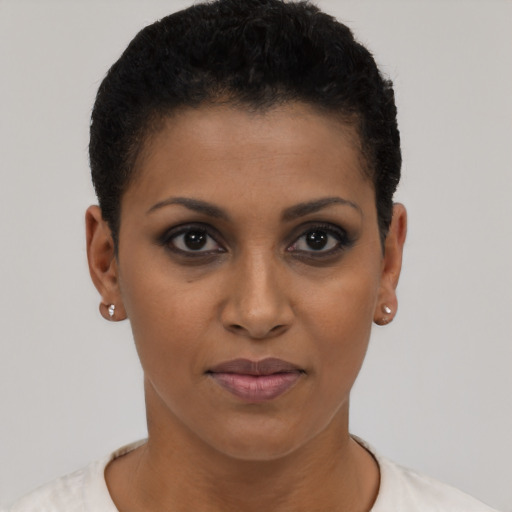 Joyful black young-adult female with short  brown hair and brown eyes