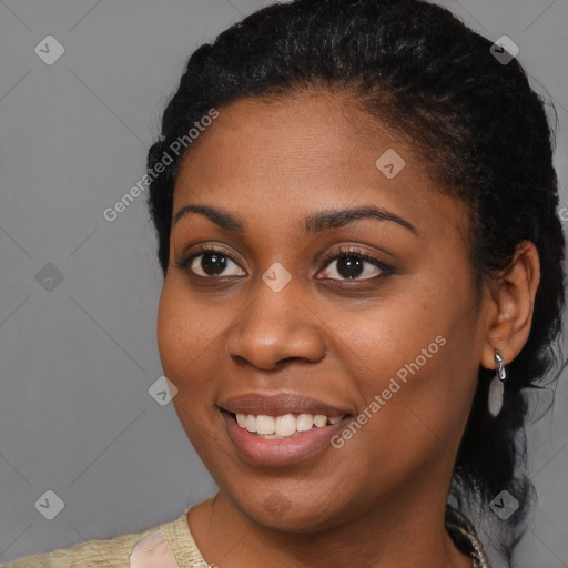 Joyful black young-adult female with short  black hair and brown eyes