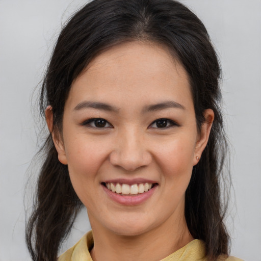 Joyful asian young-adult female with medium  brown hair and brown eyes