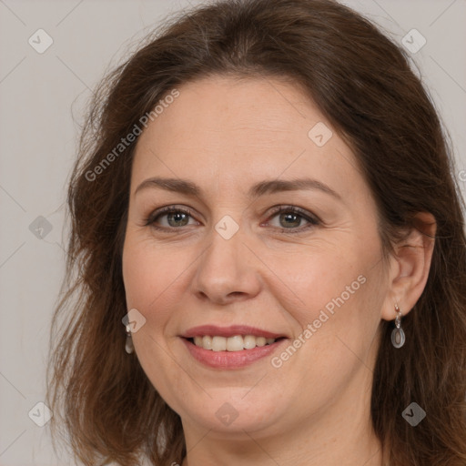 Joyful white adult female with long  brown hair and brown eyes