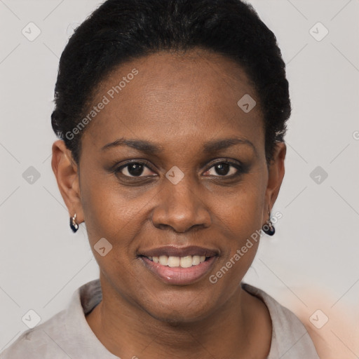 Joyful black young-adult female with short  black hair and brown eyes