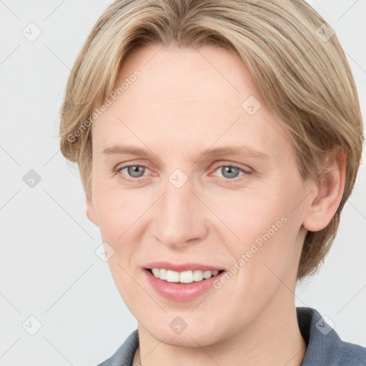 Joyful white adult female with medium  brown hair and blue eyes