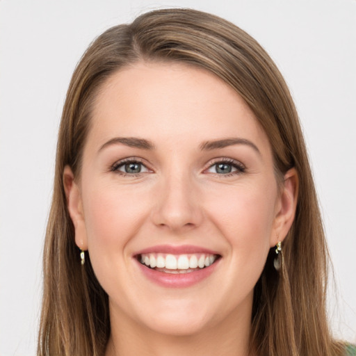 Joyful white young-adult female with long  brown hair and grey eyes