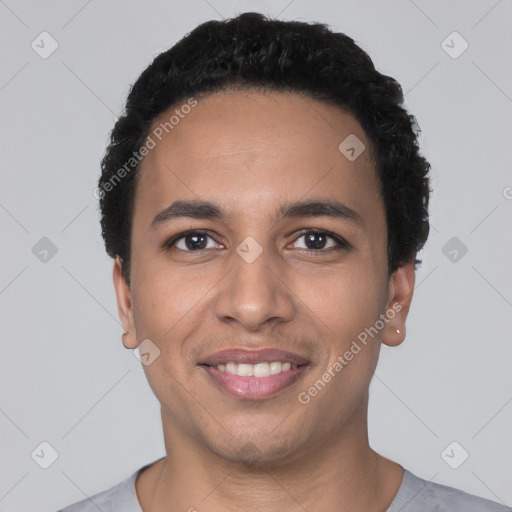 Joyful latino young-adult male with short  black hair and brown eyes