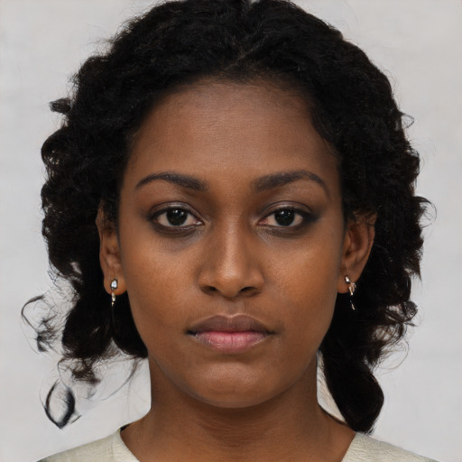 Neutral black young-adult female with medium  black hair and brown eyes