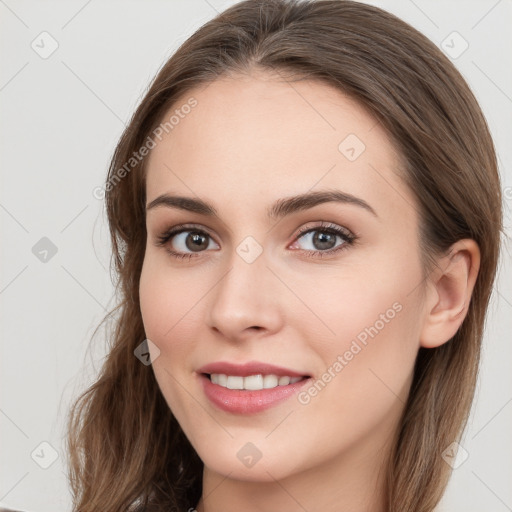 Joyful white young-adult female with long  brown hair and grey eyes