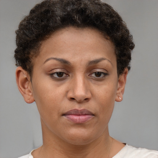 Joyful black young-adult female with short  brown hair and brown eyes
