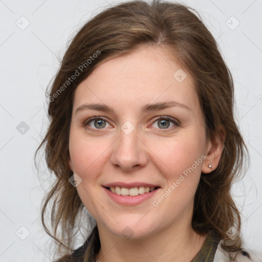 Joyful white young-adult female with medium  brown hair and grey eyes