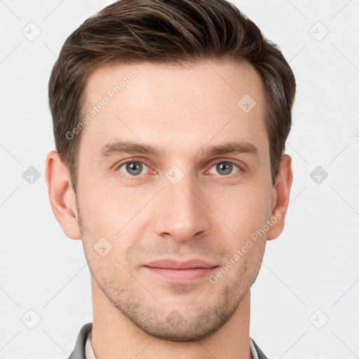 Joyful white young-adult male with short  brown hair and grey eyes