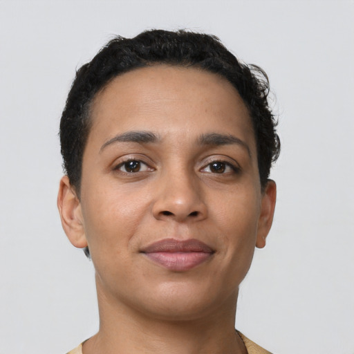Joyful latino young-adult female with short  black hair and brown eyes