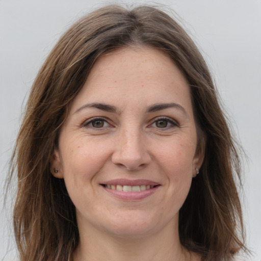 Joyful white young-adult female with long  brown hair and grey eyes