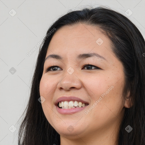 Joyful asian young-adult female with long  brown hair and brown eyes