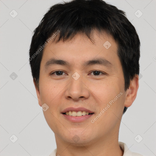 Joyful asian young-adult male with short  black hair and brown eyes