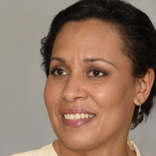 Joyful black adult female with short  brown hair and brown eyes