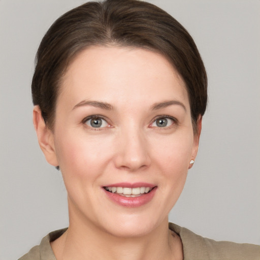 Joyful white young-adult female with short  brown hair and grey eyes