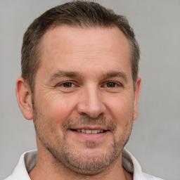 Joyful white adult male with short  brown hair and brown eyes