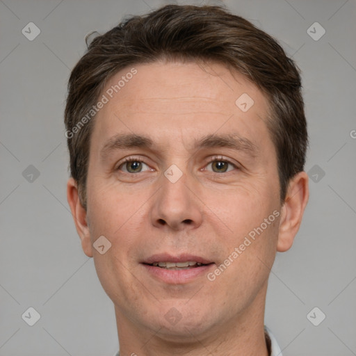 Joyful white adult male with short  brown hair and grey eyes