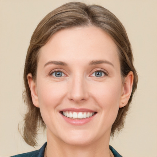 Joyful white young-adult female with medium  brown hair and blue eyes