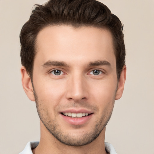 Joyful white young-adult male with short  brown hair and brown eyes