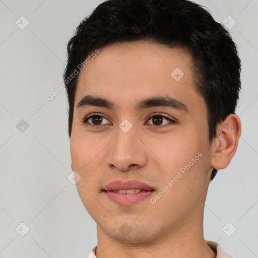 Joyful asian young-adult male with short  black hair and brown eyes