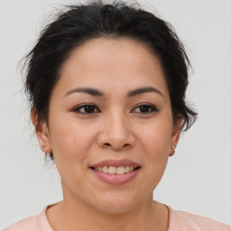 Joyful asian young-adult female with medium  brown hair and brown eyes