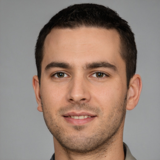 Joyful white young-adult male with short  brown hair and brown eyes