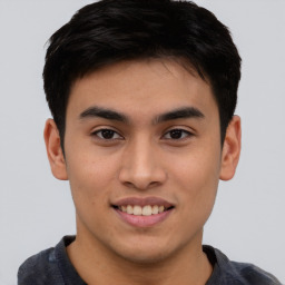 Joyful asian young-adult male with short  brown hair and brown eyes