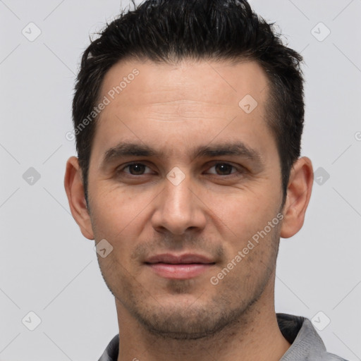 Joyful white young-adult male with short  black hair and brown eyes