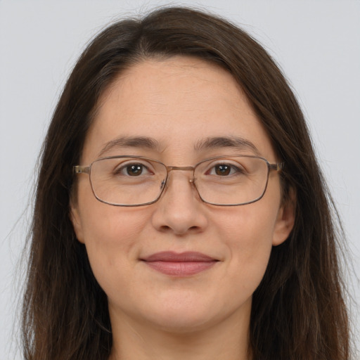 Joyful white adult female with long  brown hair and brown eyes