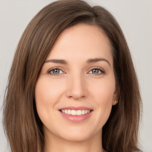 Joyful white young-adult female with long  brown hair and brown eyes