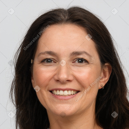 Joyful white adult female with long  brown hair and brown eyes