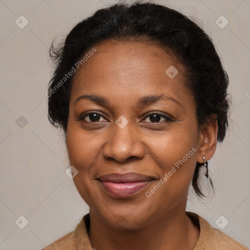 Joyful black adult female with medium  brown hair and brown eyes