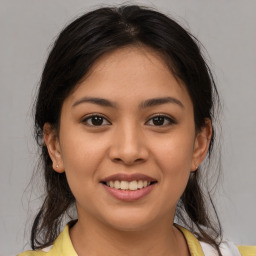 Joyful latino young-adult female with medium  brown hair and brown eyes