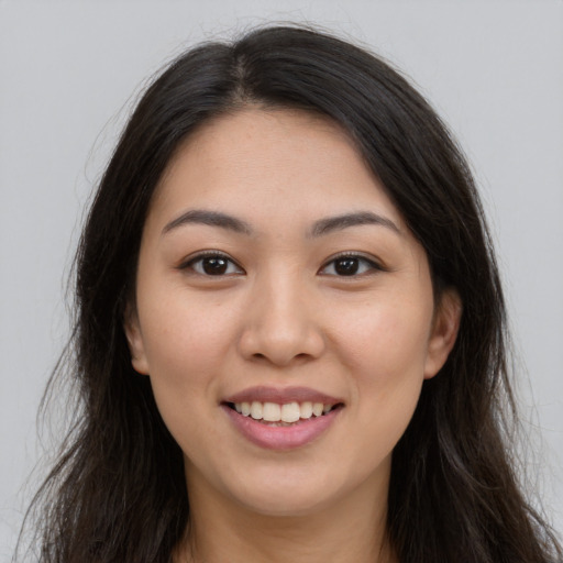 Joyful asian young-adult female with long  brown hair and brown eyes