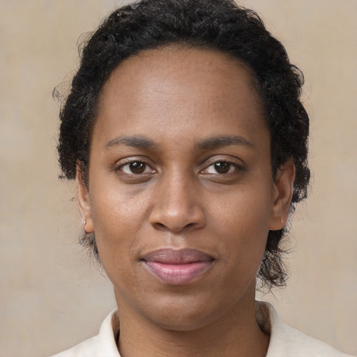 Joyful black young-adult female with short  brown hair and brown eyes