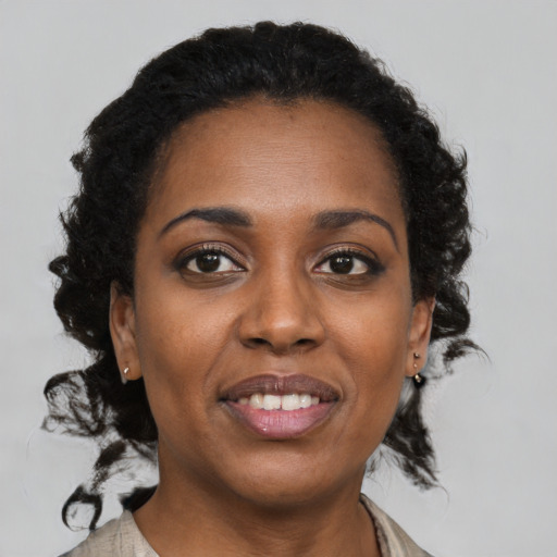 Joyful black young-adult female with medium  brown hair and brown eyes