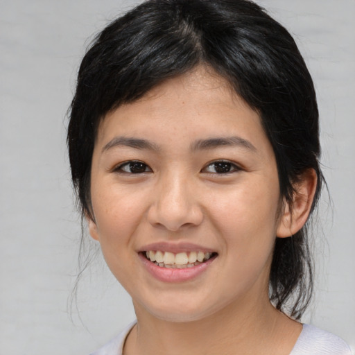 Joyful asian young-adult female with medium  black hair and brown eyes