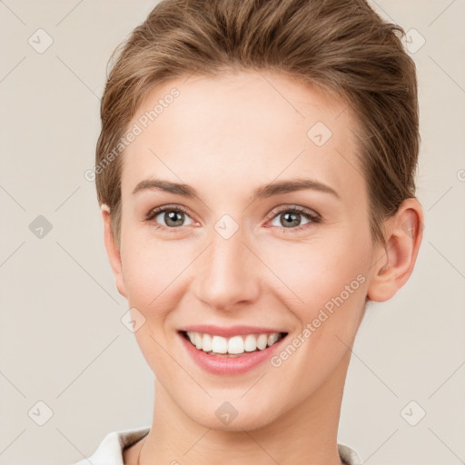 Joyful white young-adult female with short  brown hair and grey eyes