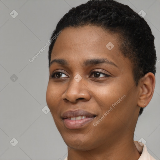 Joyful black young-adult female with short  black hair and brown eyes