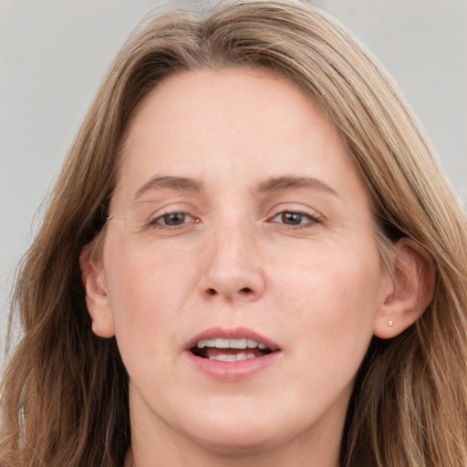 Joyful white young-adult female with long  brown hair and grey eyes