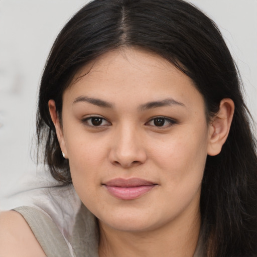 Joyful asian young-adult female with long  brown hair and brown eyes