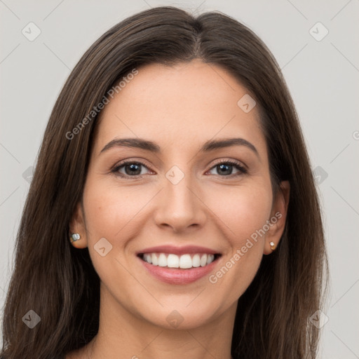 Joyful white young-adult female with long  brown hair and brown eyes