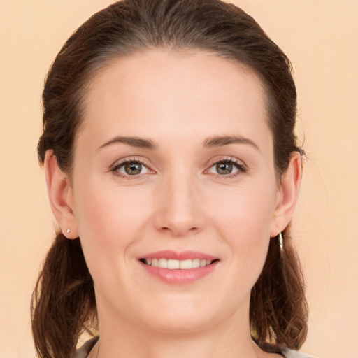 Joyful white young-adult female with medium  brown hair and brown eyes