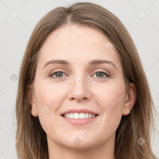 Joyful white young-adult female with long  brown hair and grey eyes