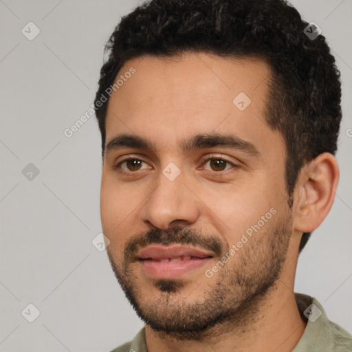 Joyful white young-adult male with short  black hair and brown eyes