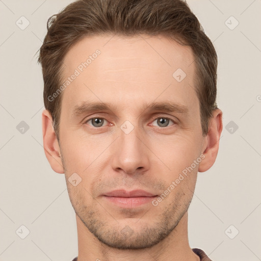 Joyful white young-adult male with short  brown hair and grey eyes