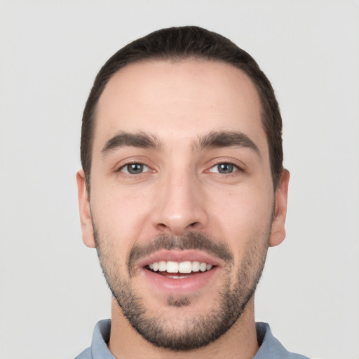 Joyful white young-adult male with short  black hair and brown eyes