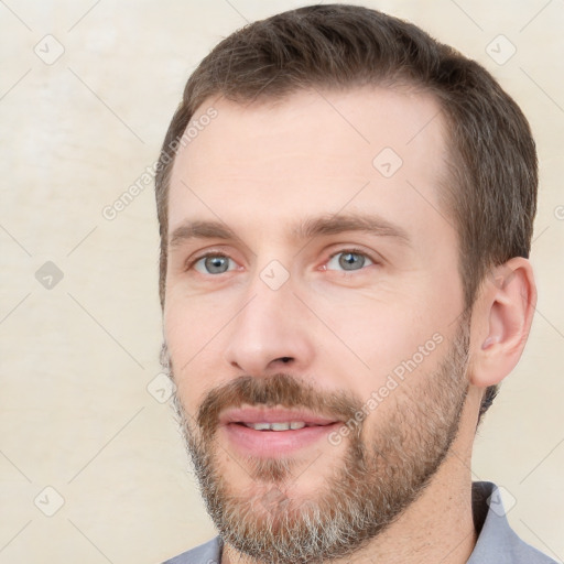 Joyful white young-adult male with short  brown hair and grey eyes